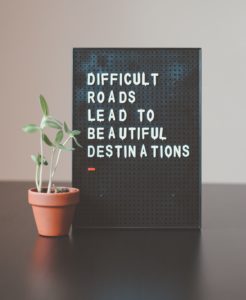 sign that says "difficult roads lead to beautiful destinations"