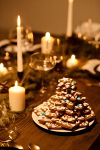 a stack of cookies on a table with candles